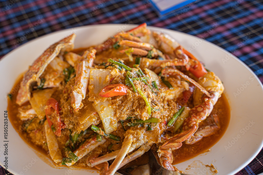 Stir-fried crab curry, soft shell crab yellow curry with sweet pepper and vegetables. in a restaurant by the sea, Phuket Stir-fried crab curry, soft shell crab yellow curry with sweet pepper and vegetables. in a restaurant by the sea, Phuket