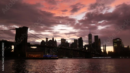 Brooklyn Bridge, New York City Manhattan downtown skyline, financial district cityscape. United States World Trade Center skyscraper. Waterfront Pebble Beach, Dumbo, USA. Dramatic twilight cloudy sky.