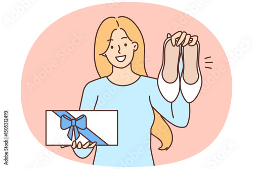 Happy woman showing new shoes and box with gift bow boasting purchase after shopping