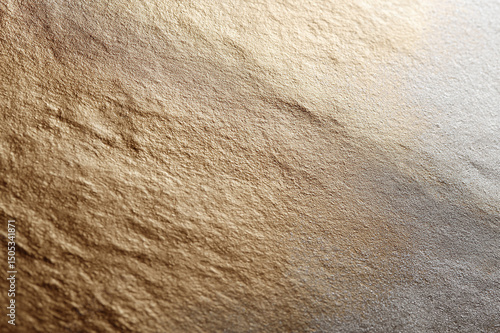 Smooth textured metallic mineral surface with gold and silver gradient, abstract background for design, elegant and luxurious appearance, closeup detail, soft lighting
