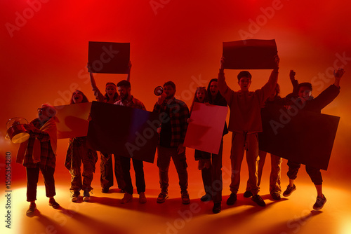 Фотография Diverse people, activists shout and hold signs in red neon fog with raised fists and megaphones