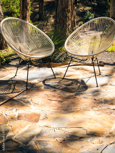 Two chairs in the afternoon sun on a patio