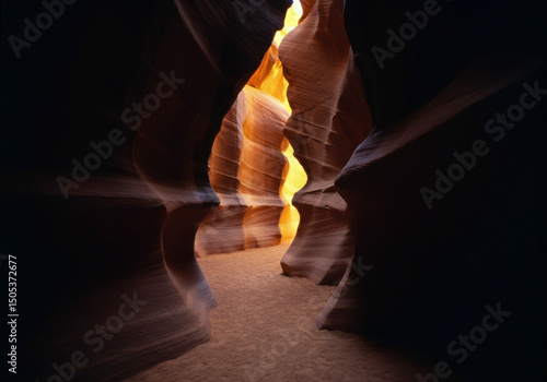 Abstract sandstone canyon formation with glowing light, natural textures and curves, ideal for travel, nature, and editorial photography stock applications.