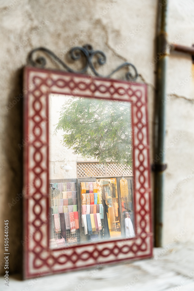 Fototapeta premium Reflection of Street market in vintage handmade mirror, Dubai Al Seef heritage market Street photography 