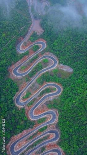 Wallpaper Mural Aerial view of Khau Coc Cha mountain pass in Bao Lac, Cao Bang, Vietnam. Empty winding road at dawn through misty hills and lush green landscape Torontodigital.ca