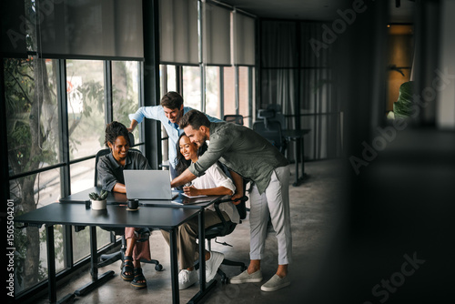 Group of young multi-ethnic startup business team collaborating on project in modern office