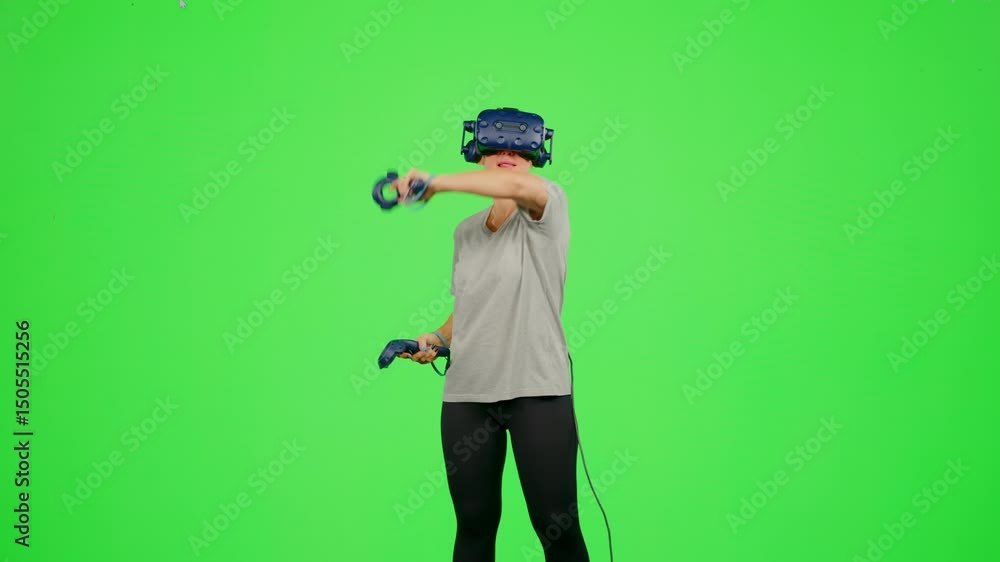 The girl gaming on chroma key green screen background in virtual reality.The woman wearing VR headset playing in virtual reality game.Concept enjoy game in VR headset leisure activity virtual reality The girl gaming on chroma key green screen background in virtual reality.The woman wearing VR headset playing in virtual reality game.Concept enjoy game in VR headset leisure activity virtual reality