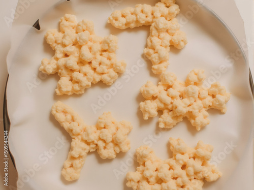 Snowflake Shaped Marshmallow Treats on Baking Sheet