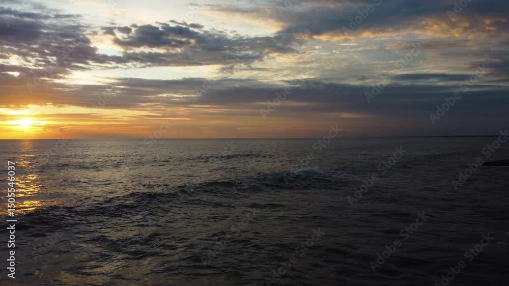 Beautiful 4K aerial drone cinemagraph / seamless video loop of a tropical Pacific paradise beach sunset at Jaco, Costa Rica, with waves and sand. A person is walking towards the shore. Beautiful 4K aerial drone cinemagraph / seamless video loop of a tropical Pacific paradise beach sunset at Jaco, Costa Rica, with waves and sand. A person is walking towards the shore.