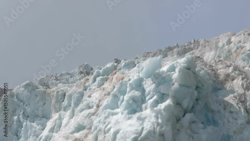 Wallpaper Mural Arctic glacier face calving into frigid ocean waters on overcast day showing melting ice and evidence of erosion Torontodigital.ca