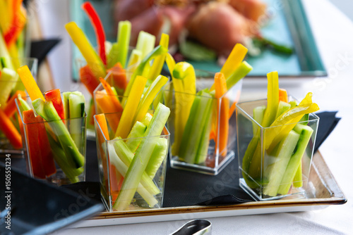 Colorful vegetable sticks served as appetizers in elegant buffet setting