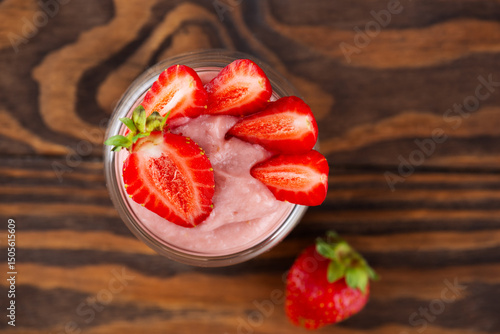 Strawberry tofu and pudding dessert on a brown wooden table. Vegan food. Lactose and sugar free. Top view.