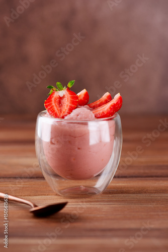 Tofu soy pink dessert with strawberry in a glass. Lactose and sugar free. Vertical orientation.