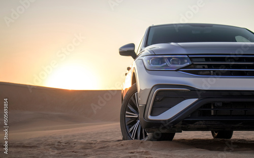 Close-up of a grey SUV in desert sand during sunset — a real and powerful image of adventure, style, and quiet strength in a dramatic natural setting.