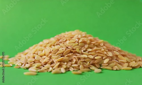 Golden Grains: A detailed view of a heap of golden-brown grains set against a vibrant green backdrop, highlighting the natural beauty and nutritional value.