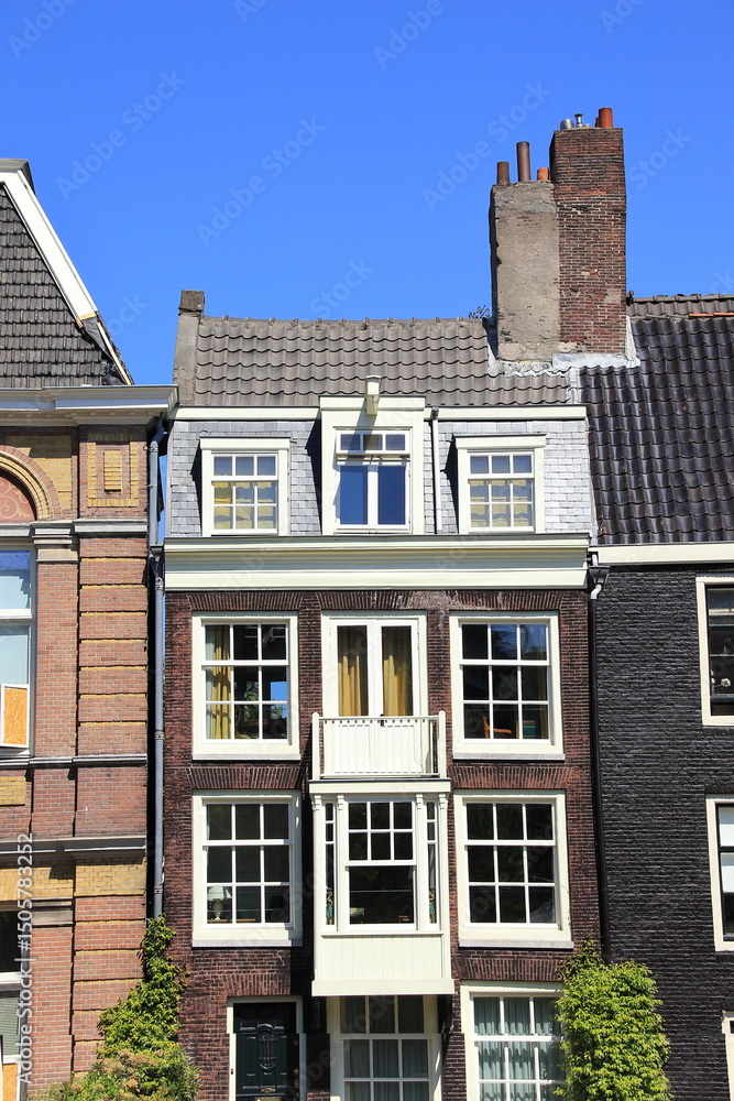 Fototapeta premium Amsterdam Canal House Facade with Big Chimneys Close Up, Netherlands