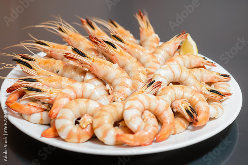 Steamed Shrimp with Lemon on a White Plate on Dark Background