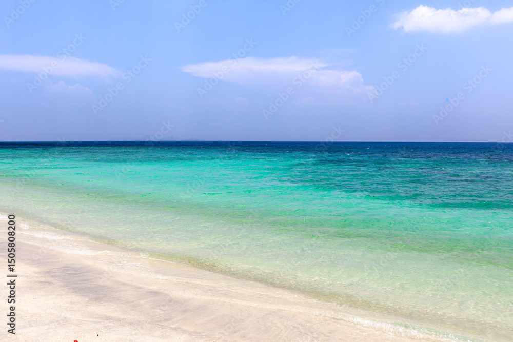 Koh Lipe, Thailand. A tranquil scene of the Andaman Sea meeting a white sand beach under a sunny sky, the beauty of this tropical island. Koh Lipe, Thailand. A tranquil scene of the Andaman Sea meeting a white sand beach under a sunny sky, the beauty of this tropical island.
