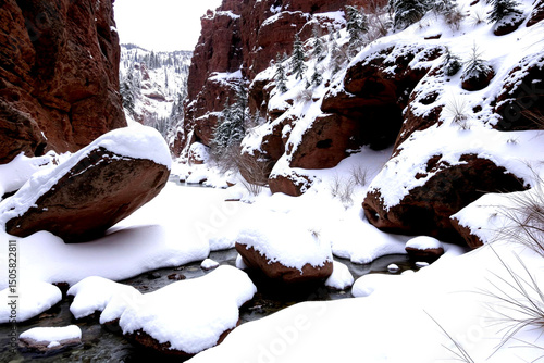 Snowy Serenity: A Winter Wonderland of Rocky Cliffs and Frozen Creek