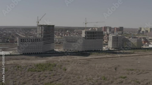 Tobolsk, drones, aerial photography, aerial view, construction of multi-storey residential buildings on the outskirts of the city, crane, builders, work, containers, monolith, from afar