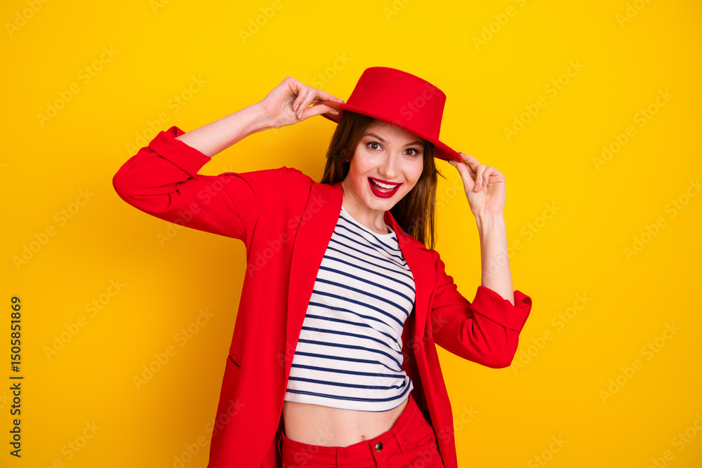 Adorable woman wearing a vibrant red outfit and hat, smiling cheerfully against a bright yellow backdrop, showcasing style and joy Adorable woman wearing a vibrant red outfit and hat, smiling cheerfully against a bright yellow backdrop, showcasing style and joy
