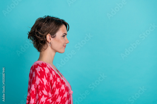Photo portrait of attractive young woman look empty space profile dressed stylish red clothes isolated on aquamarine color background