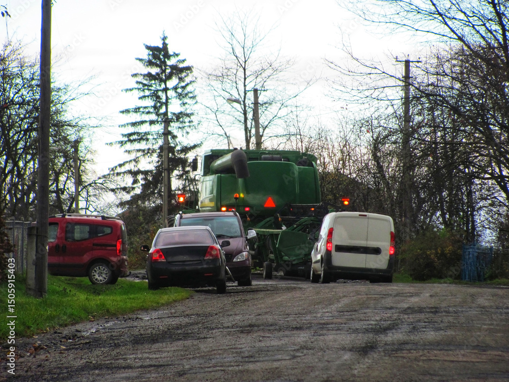 Obraz premium Various farm vehicles and machinery parked outdoors on a farm