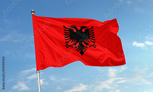 Foto Albanian national flag waving in wind with black double-headed eagle on bright r