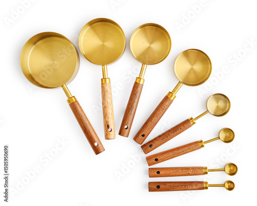 Fotografie Golden measuring spoons with wooden handles