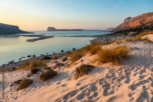 Image of Balos Bay at sunset with dry grass and soft sand at foreground, Chania, Crete
