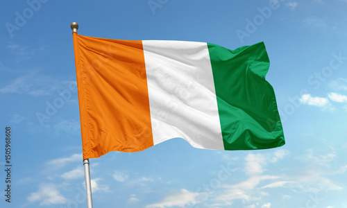 Fotografía National flag of Ivory Coast with vertical orange, white, and green stripes wavi