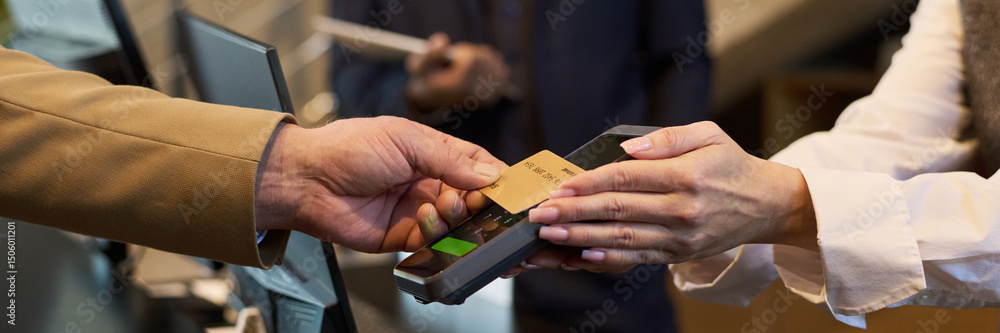custom made wallpaper toronto digitalClose-up of hands exchanging credit card at checkout terminal during payment process. Handing over card for transaction at modern point-of-sale device