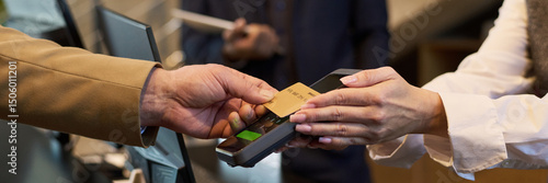 Tableau sur toile Close-up of hands exchanging credit card at checkout terminal during payment process