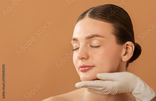 Photos Young lady with smooth skin receiving inspecting of face, cosmetologist in rubbe