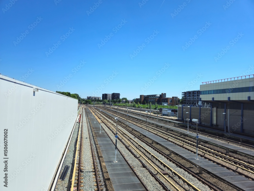 Obraz premium ROTTERDAM, NETHERLANDS,26.05.2025; The railway Station. A view from above of railroads, tracks and trains.Interior of Rotterdam Centraal subway station platform.Metro