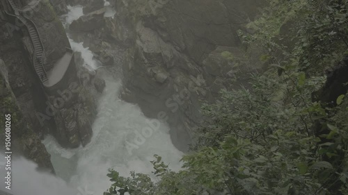 Top view of Pailon del Diablo Waterfall in Banos, Ecuador, waters plunging through green cliffs