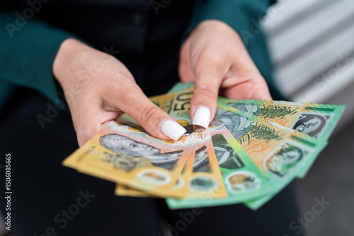 Wallpaper Mural close up woman holding lot of 50 1000 new aud australian dollar. Financial concept Torontodigital.ca
