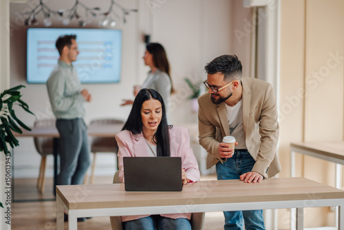 Wallpaper Mural Business colleagues collaborating on laptop in modern office Torontodigital.ca