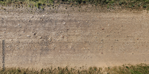 top view of gravel road surface and grass shoulder
