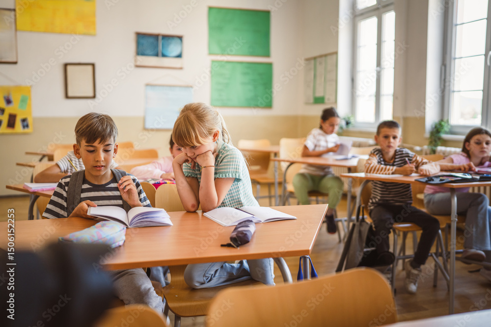 Obraz premium school girl and boy pupils attend class in the classroom