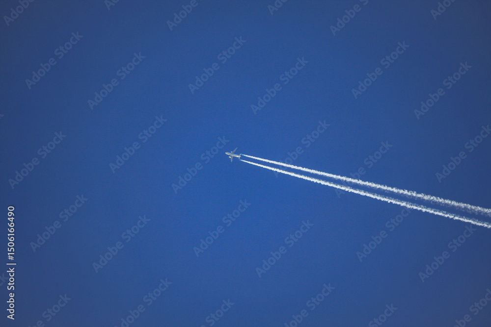 Airplane with contrail in blue sky – Tirol, Austria – December 3, 2009 Airplane with contrail in blue sky – Tirol, Austria – December 3, 2009