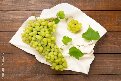 Fresh green grape on wooden background, top view