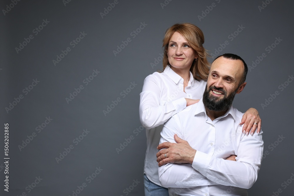 Obraz premium Portrait of lovely couple on grey background, space for text