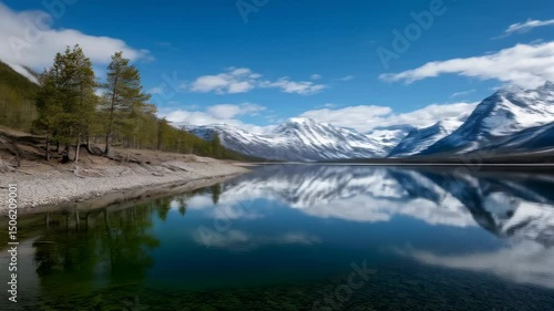 Wallpaper Mural Scenic mountain landscape featuring snow capped peaks reflected in a serene lake under a bright sky with scattered clouds in natural environment. Torontodigital.ca