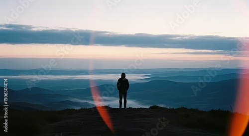 Person Overlooking Mountain Landscape at Sunset
