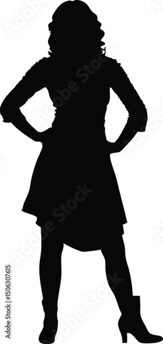 Silhouette of a confident woman in dress and boots with hands on hips