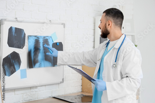 Male doctor studying x-ray ...