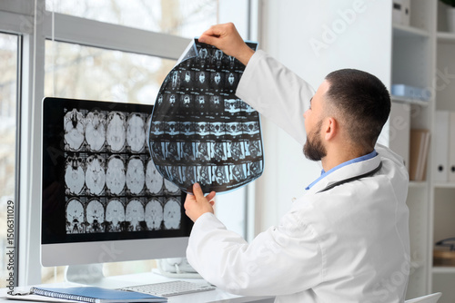 Male doctor studying MRI sc...
