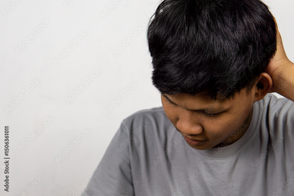 Portrait Of Depressed Young Indonesian Man, Suffering Life Problems Or Mental Breakdown, Feeling Despair, Copy Space Portrait Of Depressed Young Indonesian Man, Suffering Life Problems Or Mental Breakdown, Feeling Despair, Copy Space