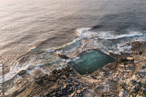 Stunning early morning aerial view of the Maroubra Rockpool in Sydney, Australia. Captured by drone at sunrise, showcasing natural beauty and coastal serenity.